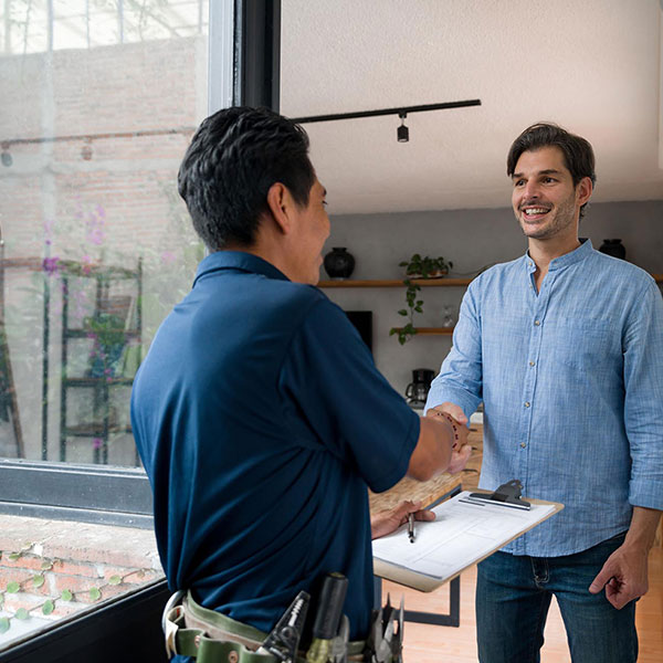 technician shaking hands with homeowner